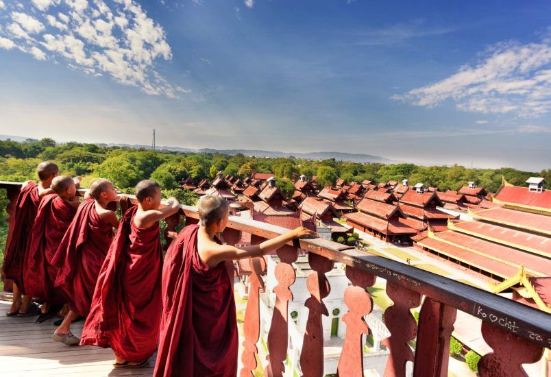 Young monks are watching kings palace in Mandalay